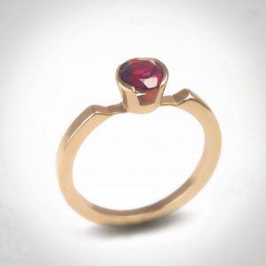 Alma Ring - 14k yellow gold ring with a 5mm round facet cut Rubi stone